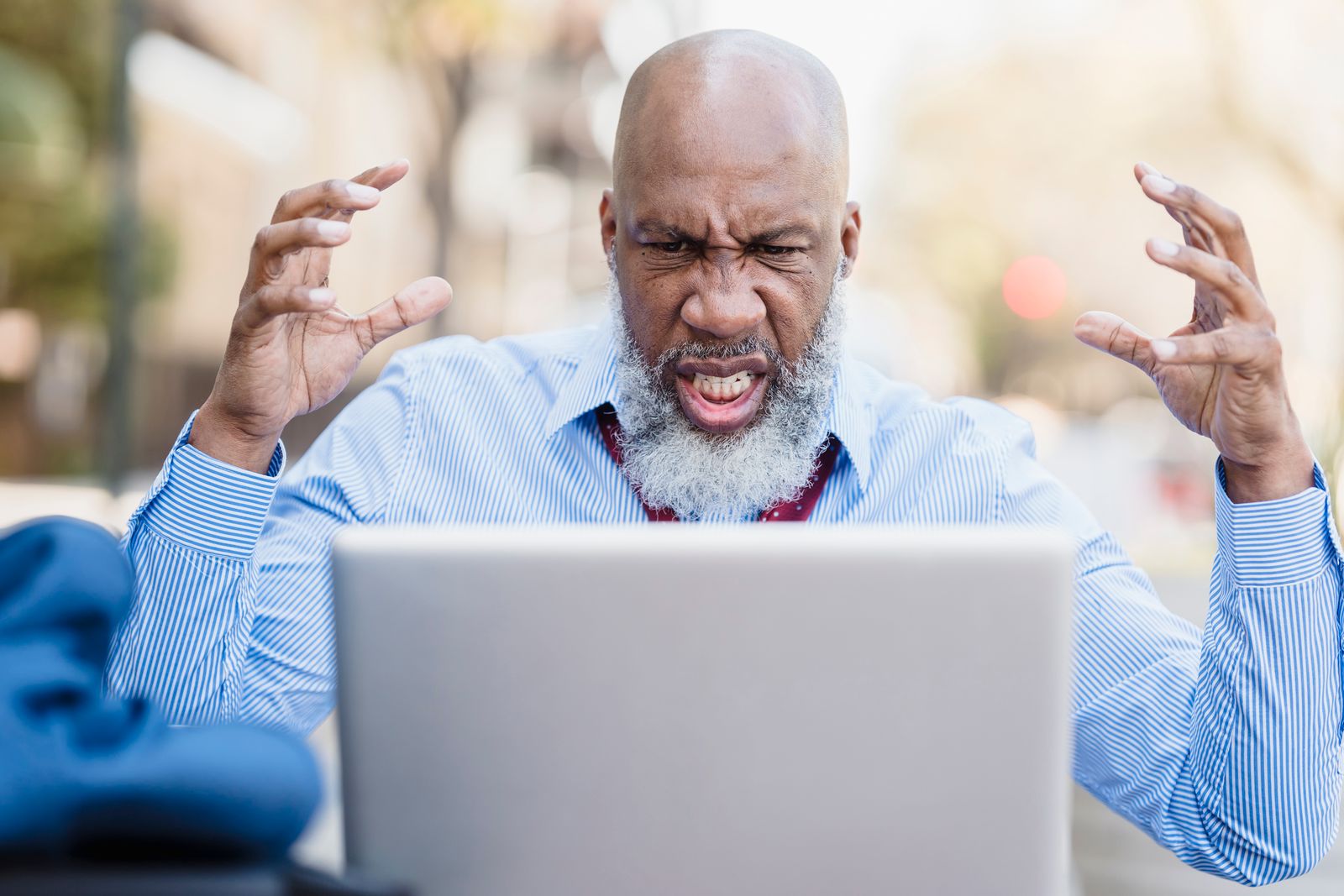 A frustrated professional during an online conversation at his laptop