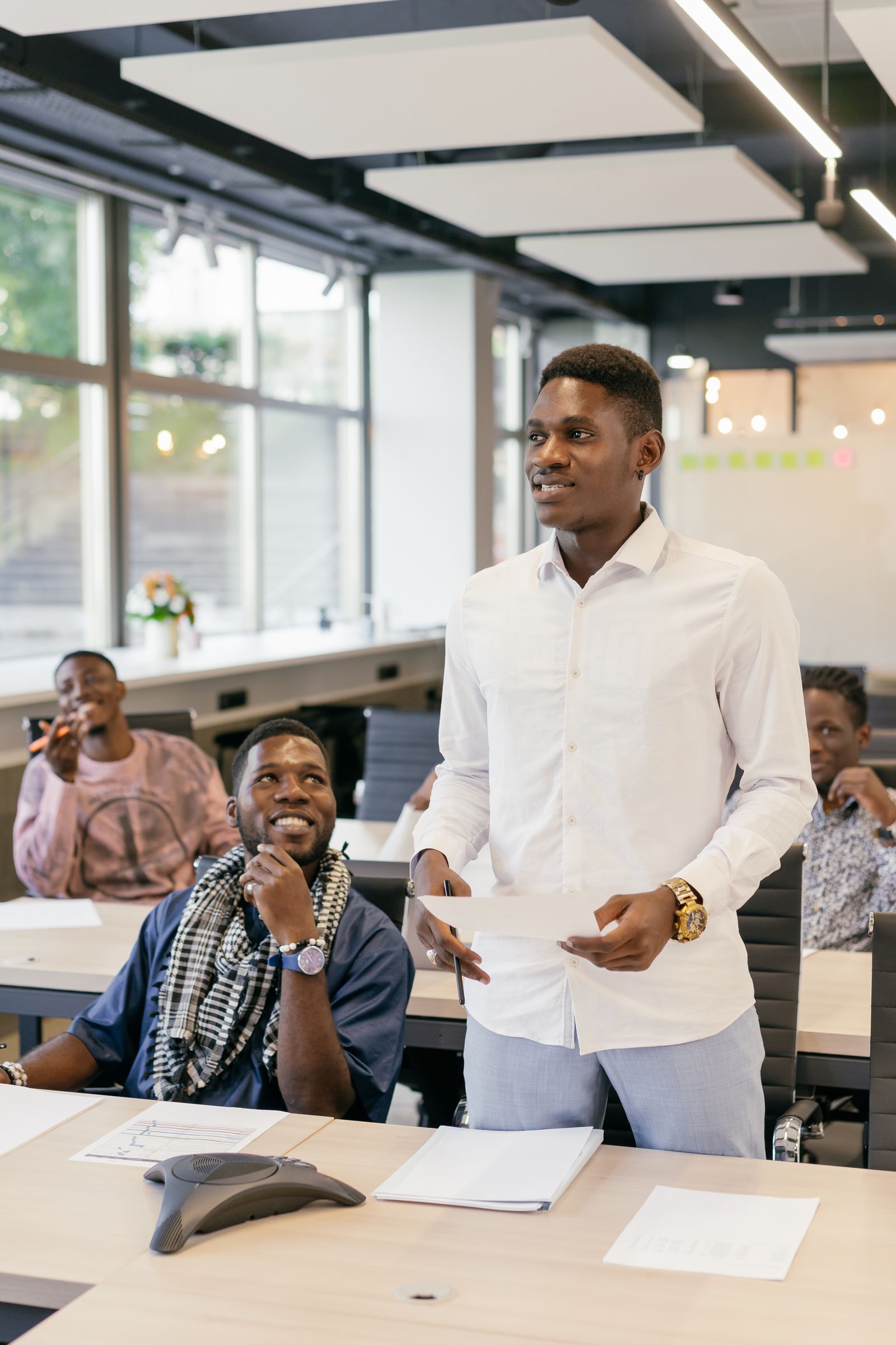 A business leader presenting to colleagues in a conference room
